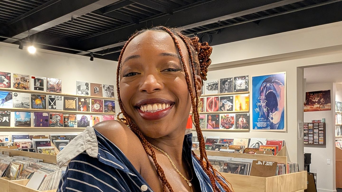 Daniella smiling in a record shop